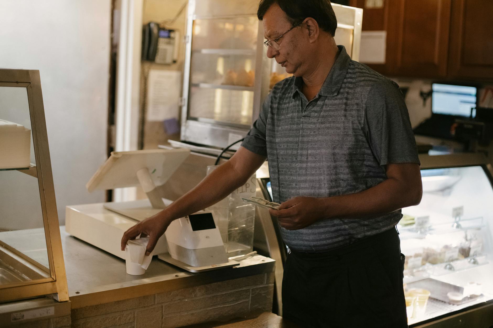 ethnic man with cup of coffee at counter